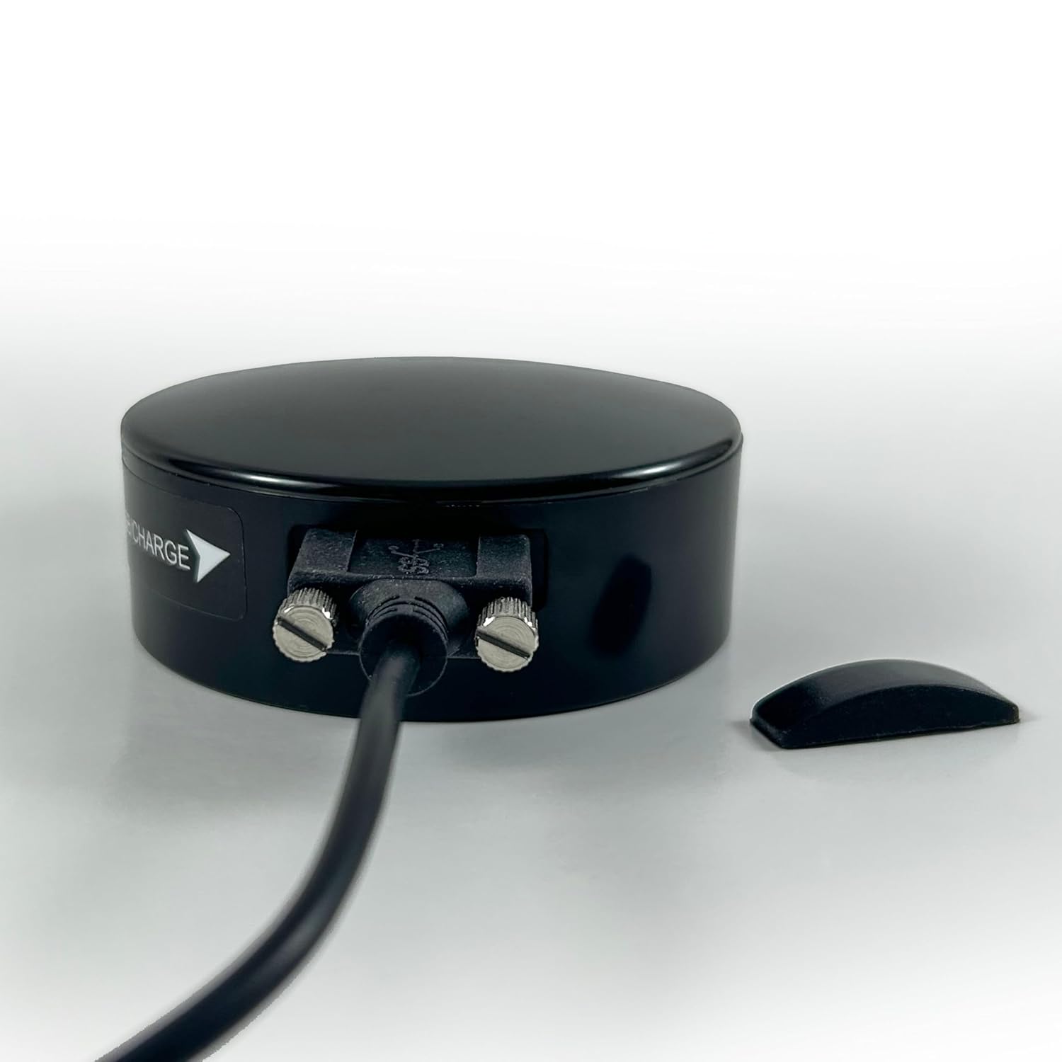 Compact black GPS tracking device, suitable for vehicle installation and real-time tracking.