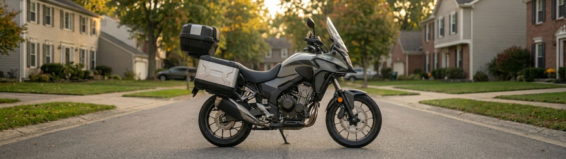 A motorcycle parked on the street of a suburban neighborhood.